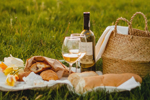 Beautiful picnic arrangement of wine and fresh products from anniversary hampers