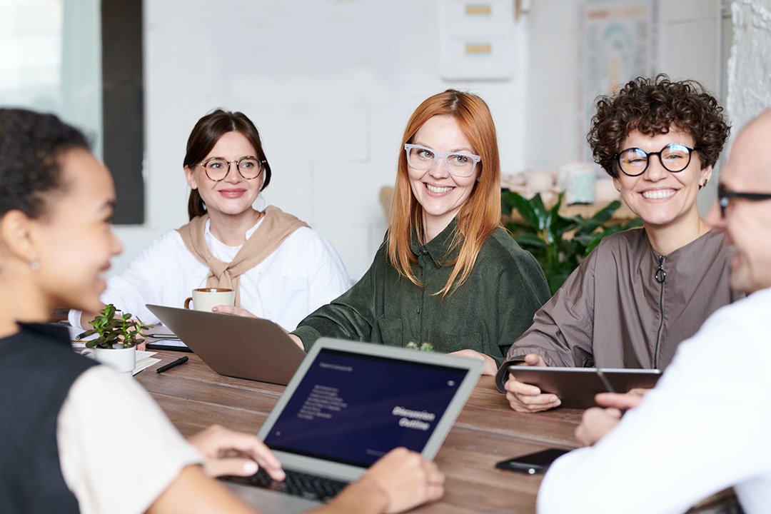 Employees smiling during a staff meeting