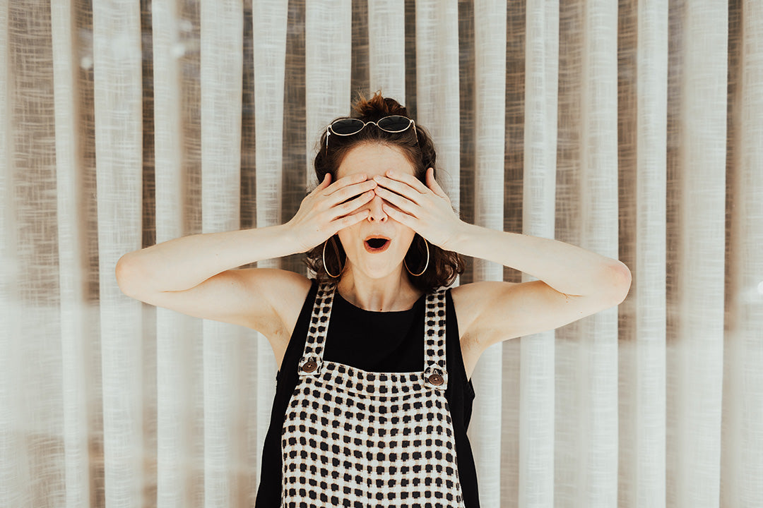Surprised woman covering her eyes