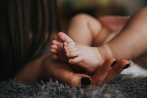 Mother holding her baby's feet